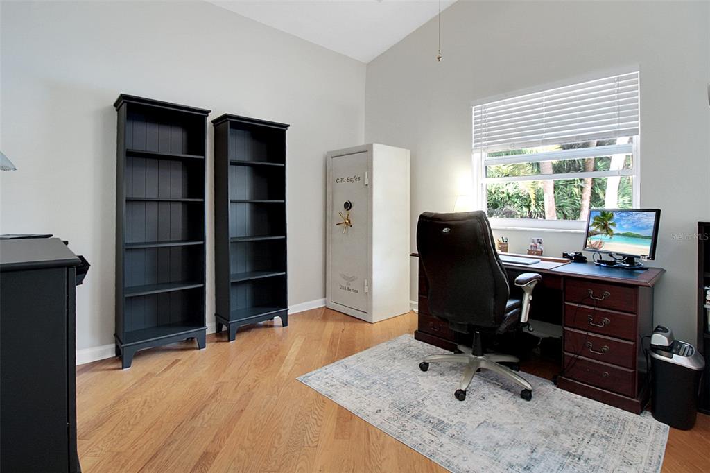 14481 Southwest 20th Street Davie, FL 33325 - Photo 28 of 36 a room with a desk and chair with wooden floor