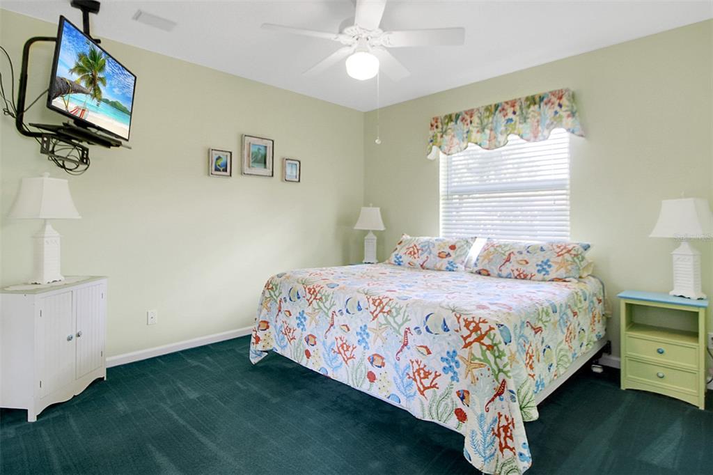 14481 Southwest 20th Street Davie, FL 33325 - Photo 30 of 36 a bedroom with a bed and a chandelier