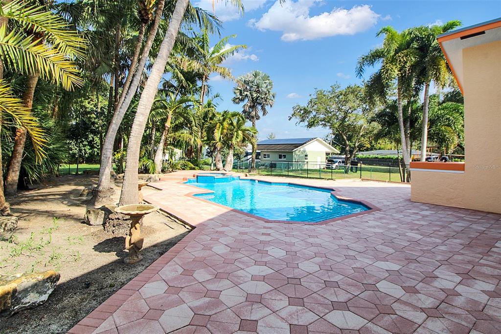 14481 Southwest 20th Street Davie, FL 33325 - Photo 3 of 36 a view of a swimming pool with a lounge chairs