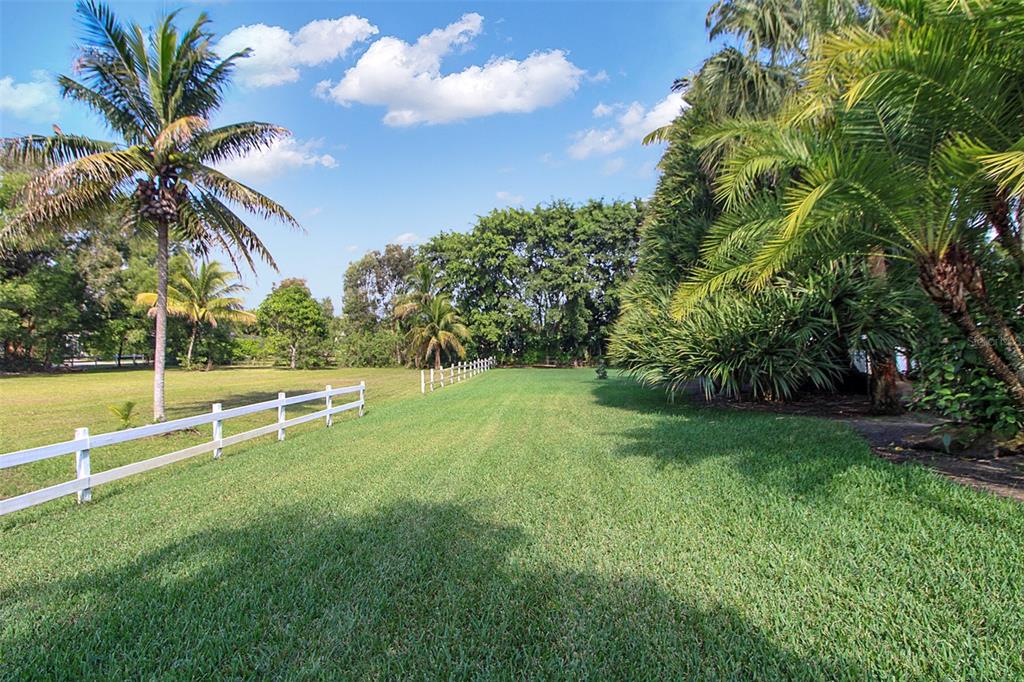 14481 Southwest 20th Street Davie, FL 33325 - Photo 33 of 36 a view of a garden with a bench