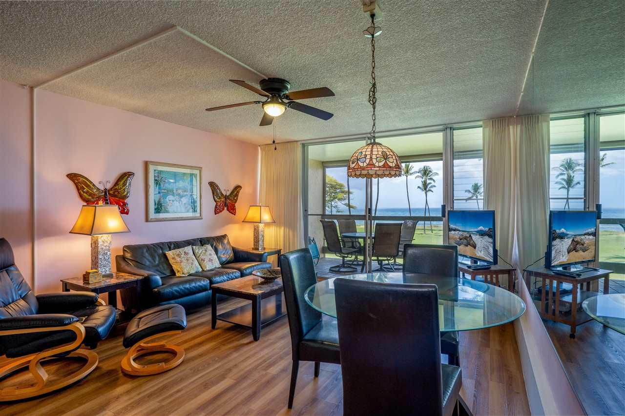 998 South Kihei Road, Unit 304 Kihei, HI 96753 - Photo 1 of 26 a living room with furniture a flat screen tv and a table