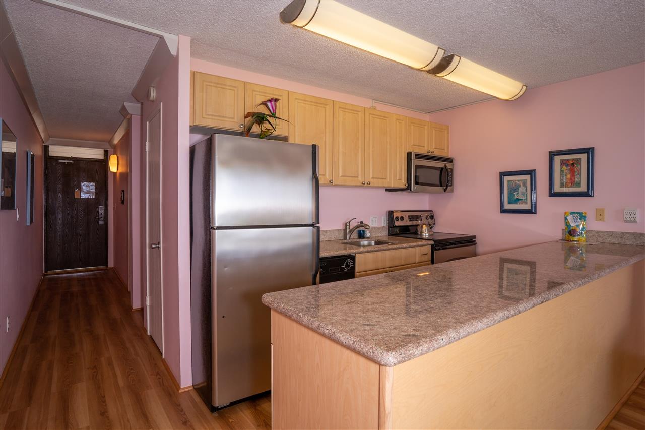 998 South Kihei Road, Unit 304 Kihei, HI 96753 - Photo 13 of 26 a kitchen with stainless steel appliances granite countertop a refrigerator and a sink