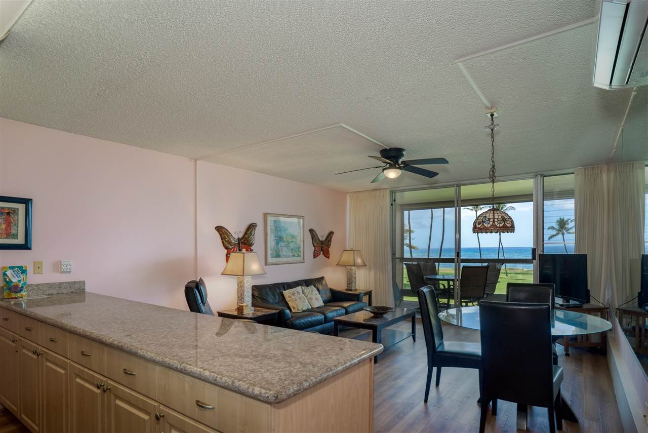 998 South Kihei Road, Unit 304 Kihei, HI 96753 - Photo 14 of 26 a living room with granite countertop furniture a dining table with wooden floor