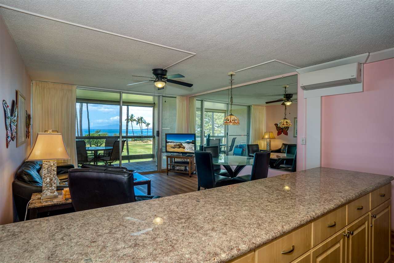 998 South Kihei Road, Unit 304 Kihei, HI 96753 - Photo 15 of 26 a kitchen with sink refrigerator and large window