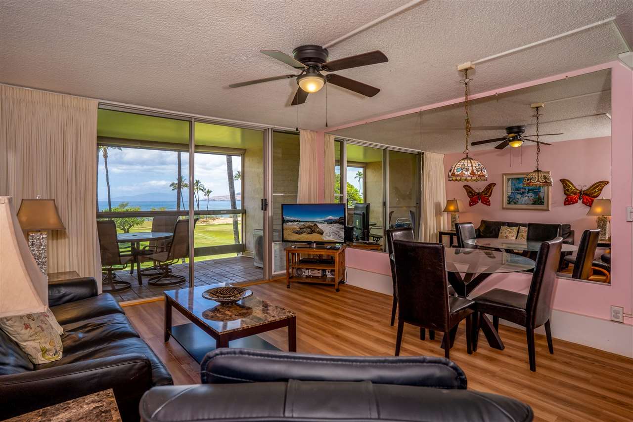998 South Kihei Road, Unit 304 Kihei, HI 96753 - Photo 4 of 26 a living room with furniture a fireplace and a flat screen tv