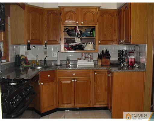 5 Laythan Road Edison, NJ 08817 - Photo 2 of 11 a kitchen with stainless steel appliances granite countertop a stove a sink dishwasher and cabinets with wooden floor