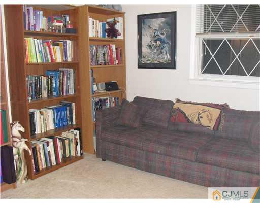 5 Laythan Road Edison, NJ 08817 - Photo 7 of 11 a living room with lots of furniture and a book shelf
