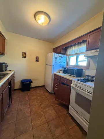 a kitchen with a stove a sink and a microwave