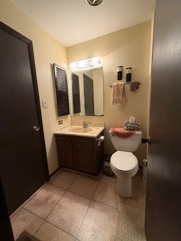 a bathroom with a sink a toilet and mirror