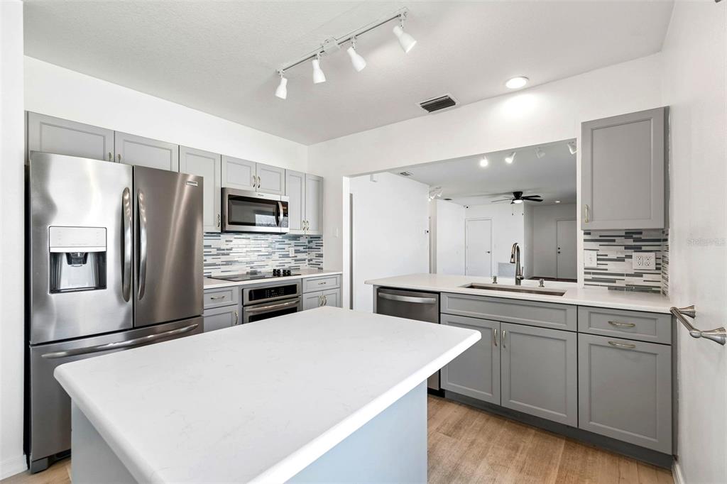 5311 Watson Road Riverview, FL 33578 - Photo 15 of 33 a large kitchen with a sink stainless steel appliances and cabinets
