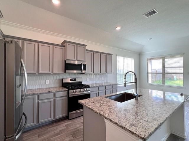 4826 Albany Ridge Lane Rosharon, TX 77583 - Photo 10 of 37 a kitchen with stainless steel appliances granite countertop a sink a stove and a refrigerator