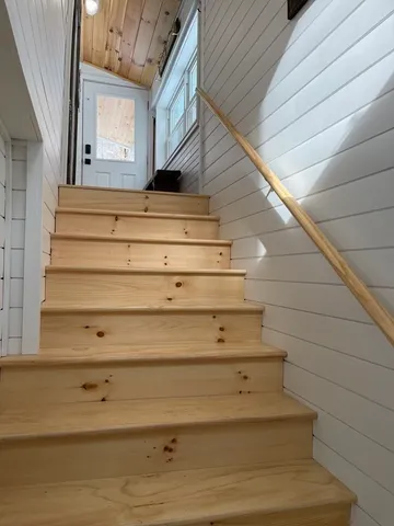 a bed sitting in a room next to a window