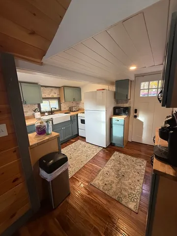 a bathroom with a sink a toilet a mirror and shower