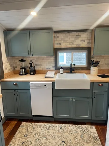 a kitchen with a sink cabinets and appliances