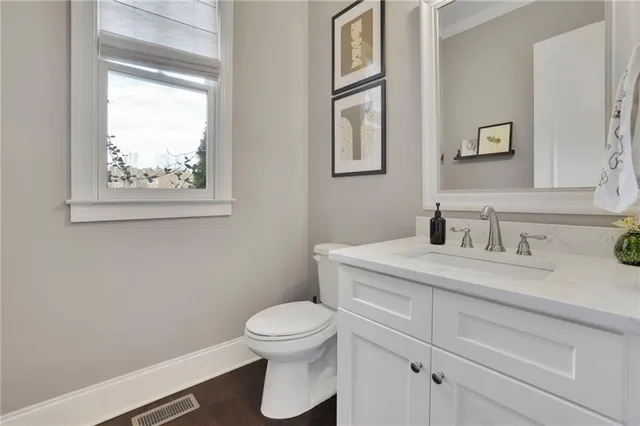 an open kitchen with white cabinets and stainless steel appliances