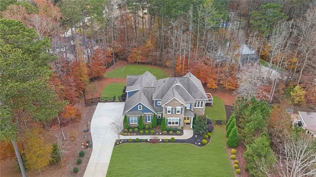 a front view of a house with swimming pool having outdoor seating