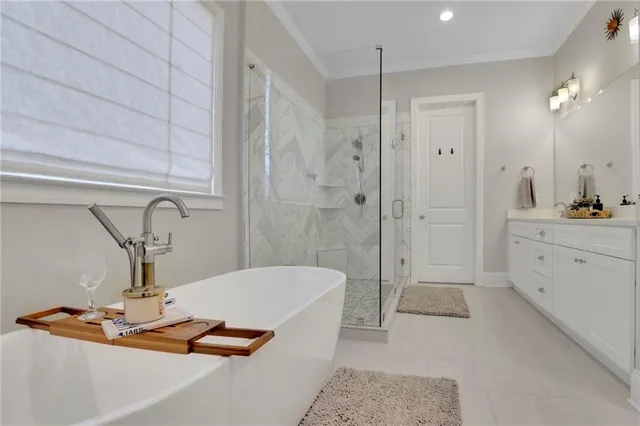 a bathroom with a bathtub sink vanity and toilet