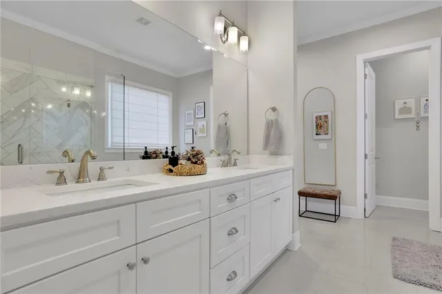 a bathroom with a granite countertop toilet sink and mirror