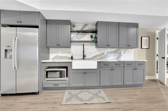 a view of a house with a big yard plants and large trees