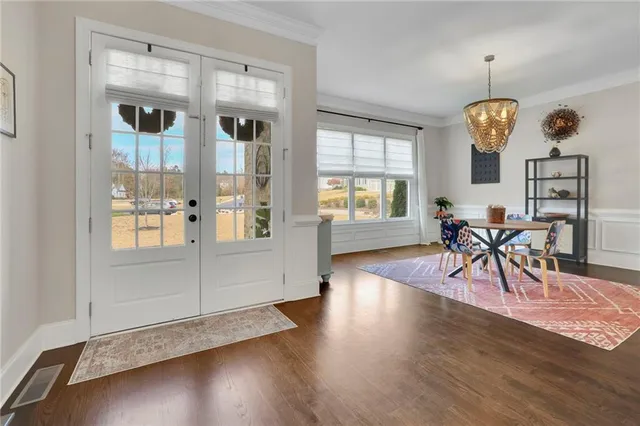 a view of entryway and hall with wooden floor
