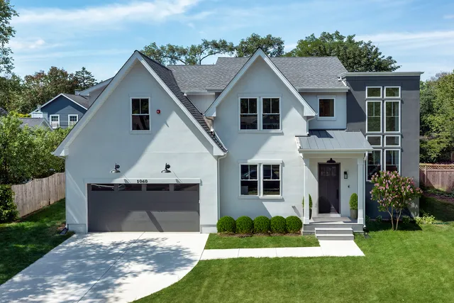 a aerial view of a house with swimming pool next to a yard