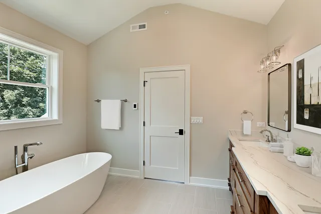 a picture of a bathroom with a shower and a mirror