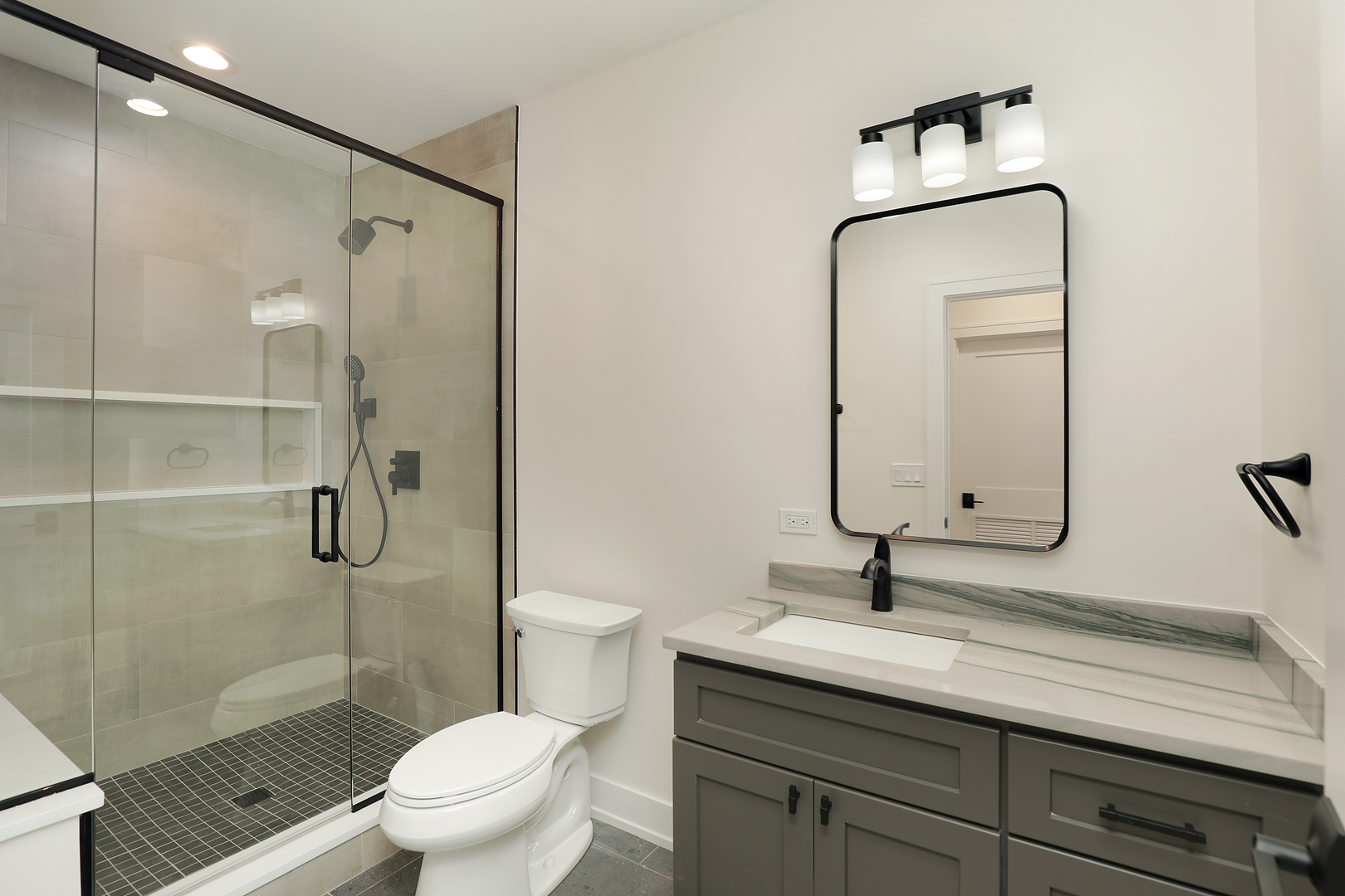 1060 Cedar Lane Northbrook, IL 60062 - Photo 25 of 31 a bathroom with a toilet sink shower and mirror