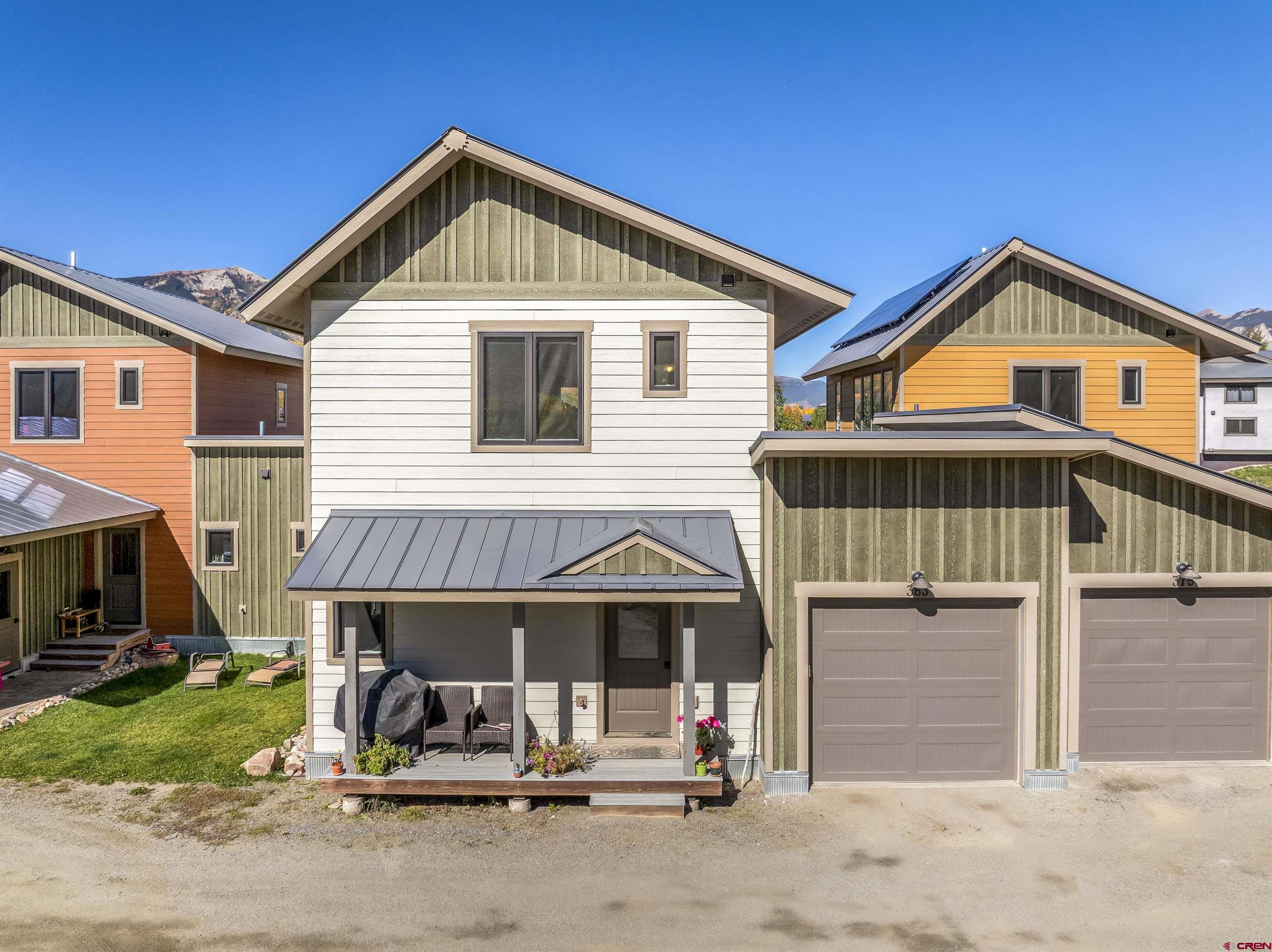 363 Cement Creek Road, Unit 3 Crested Butte, CO 81224 - Photo 32 of 34 a front view of a house with a yard and garage