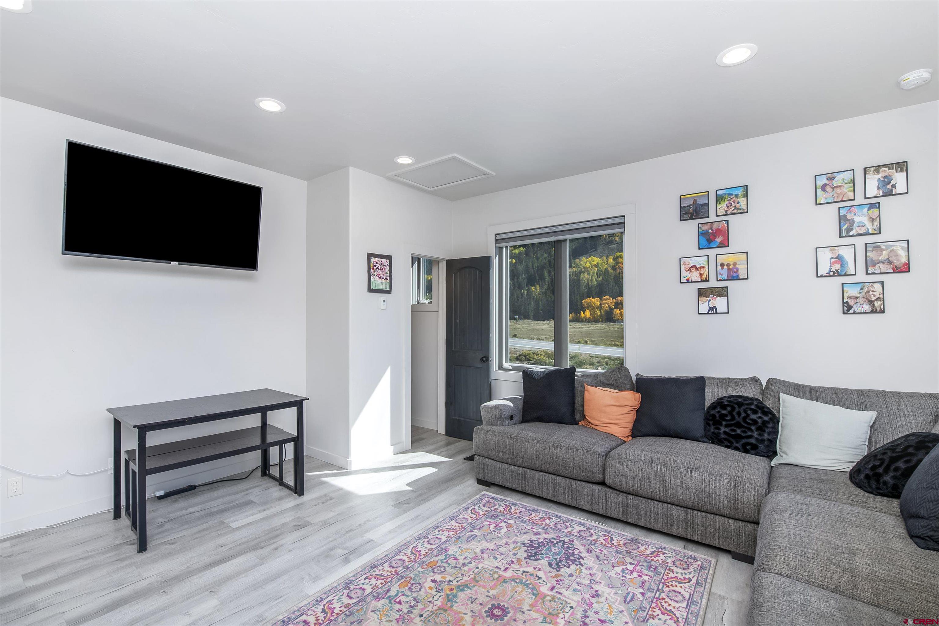 363 Cement Creek Road, Unit 3 Crested Butte, CO 81224 - Photo 7 of 34 a living room with furniture and a flat screen tv
