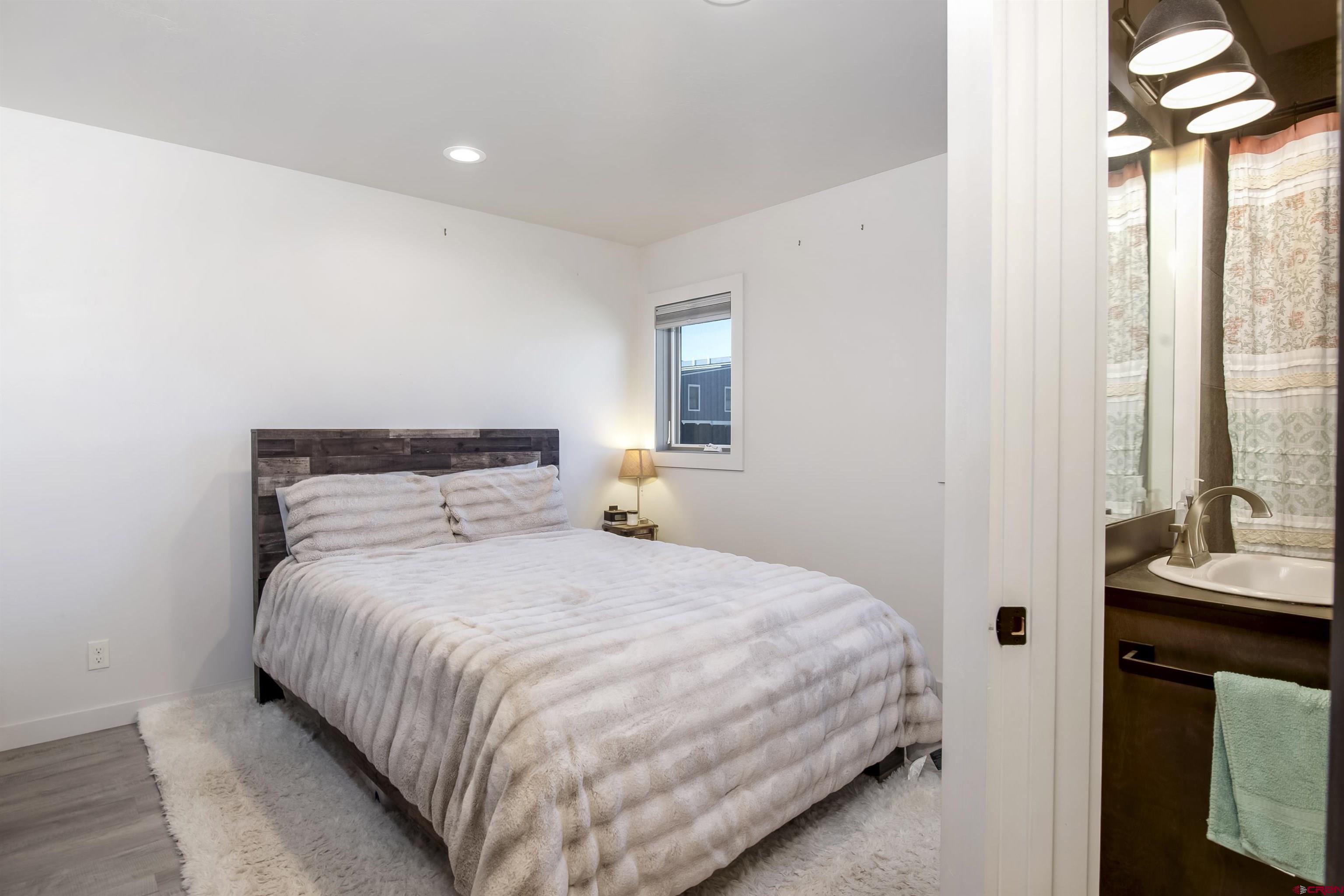 363 Cement Creek Road, Unit 3 Crested Butte, CO 81224 - Photo 9 of 34 a bedroom with a bed and a night stand