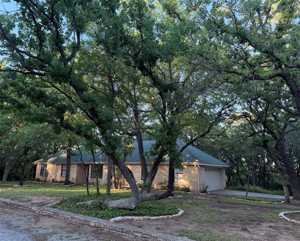 150 Timberidge Lake Road Graham, TX 76450 - Photo 2 of 25 a front view of a house with a yard and tree