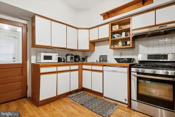 a kitchen with stainless steel appliances granite countertop a stove and a sink