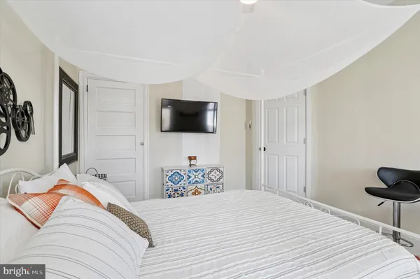 a bedroom with a bed and a window