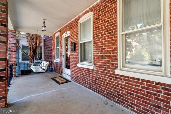 a view of a porch with wooden floor and a ceiling fan