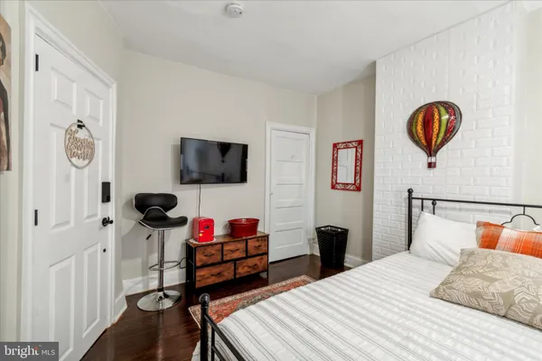 a bedroom with a bed dresser and a window