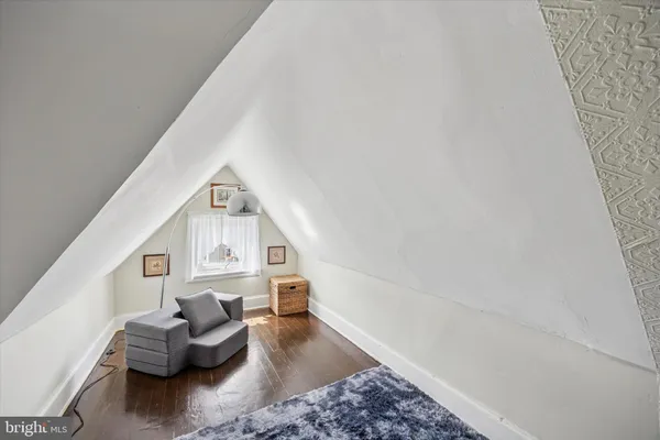 a view of a hallway with wooden floor and stairs