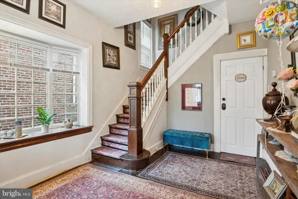 a view of entryway with wooden floor and stairs