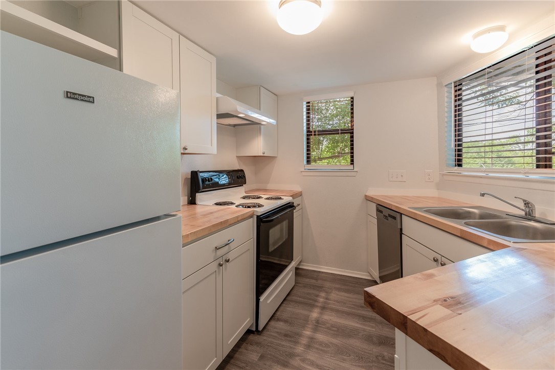 2500 Burleson Road, Unit 614 Austin, TX 78741 - Photo 6 of 20 a kitchen with stainless steel appliances granite countertop a sink stove and refrigerator