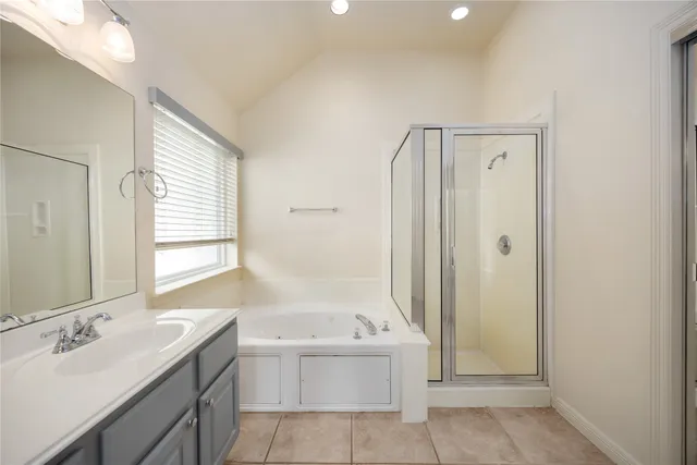 a bathroom with a tub sink and mirror