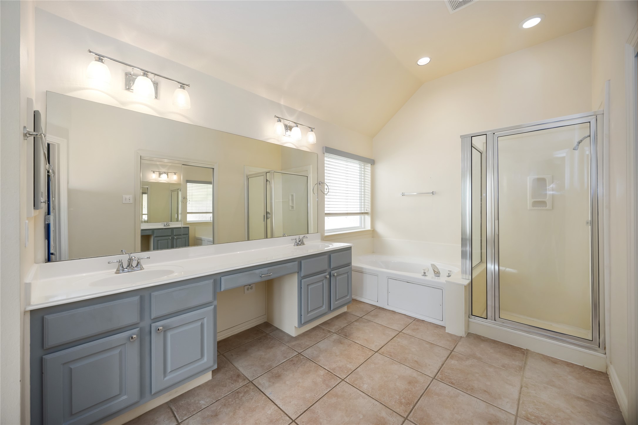 25619 Myrtle Springs Spring, TX 77373 - Photo 19 of 29 a large bathroom with a large mirror vanity and shower