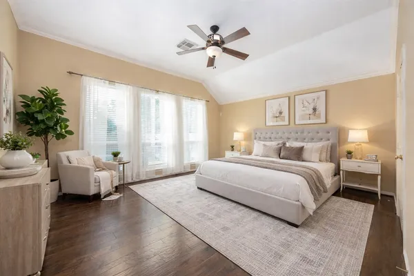 a spacious bedroom with a bed and a couch