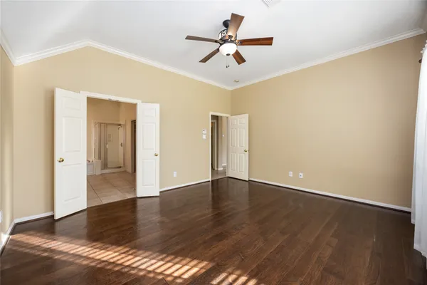 a view of an empty room with wooden floor