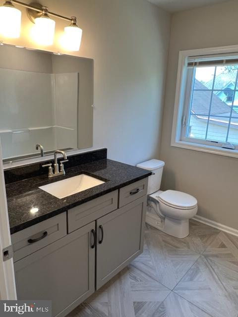 215 East Linden Street, Unit 4 Kennett Square, PA 19348 - Photo 14 of 23 a bathroom with a sink a toilet and a mirror