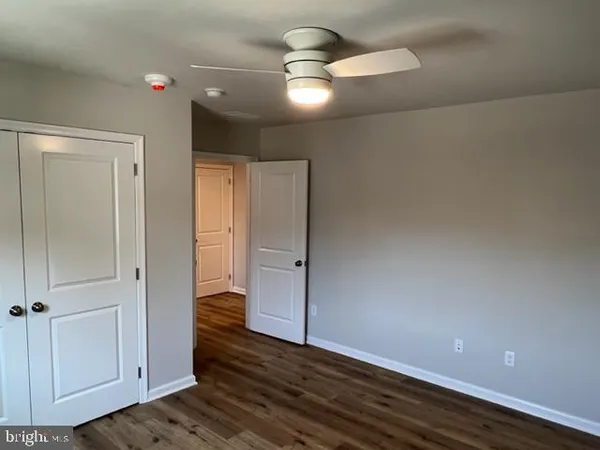 a view of an empty room and wooden floor