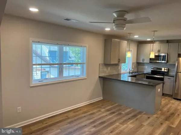 a kitchen with granite countertop a stove and a sink