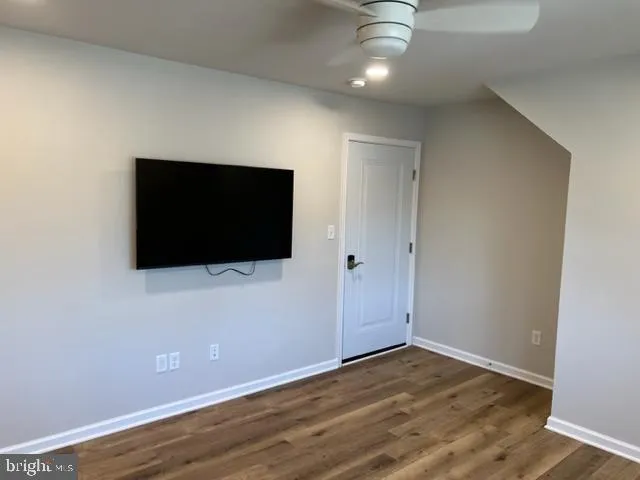 a view of a livingroom with wooden floor and flat screen tv