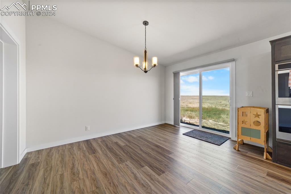 38640 Jones Road Rush, CO 80833 - Photo 13 of 41 a view of an empty room with wooden floor and a window
