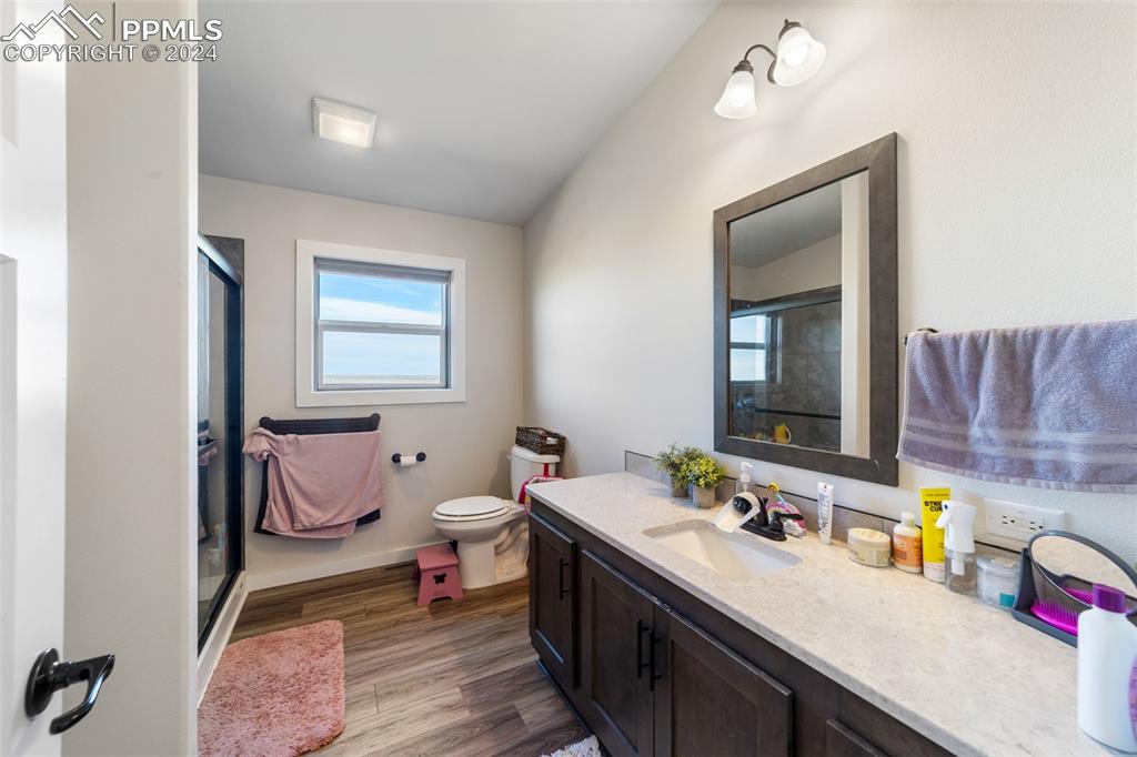 38640 Jones Road Rush, CO 80833 - Photo 26 of 41 a spacious bathroom with a double vanity sink a mirror and a toilet