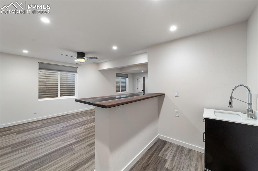 38640 Jones Road Rush, CO 80833 - Photo 29 of 41 a kitchen with kitchen island a sink wooden floor and a window