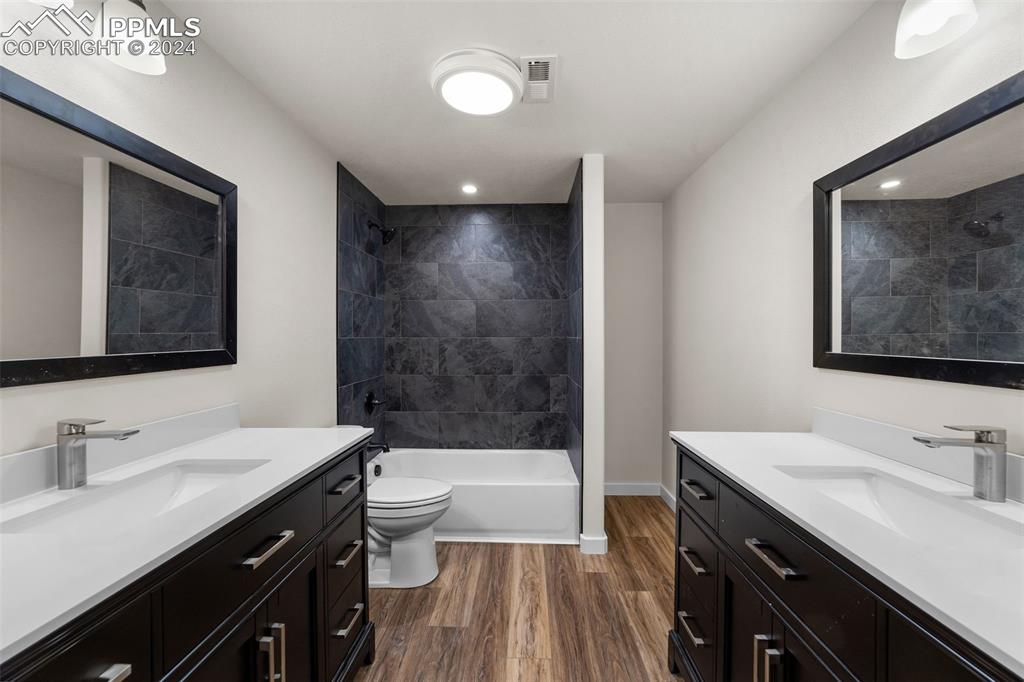 38640 Jones Road Rush, CO 80833 - Photo 31 of 41 a bathroom with a double vanity sink a mirror and a bathtub